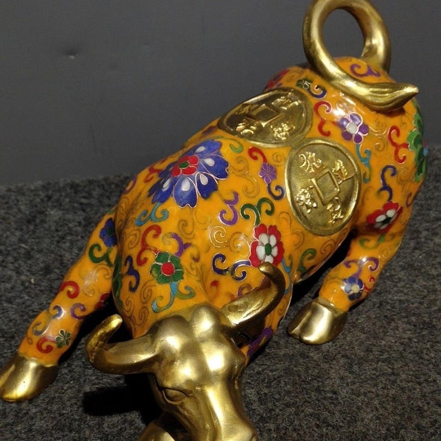 This striking vintage cloisonne enamel figurine depicts a powerful bull or ox in a dynamic, charging pose, a traditional...
