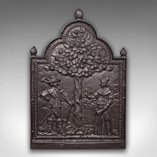 This is an antique decorative fire back. An English, cast iron fireplace hearth backrest with Tree of Life scene, dating...