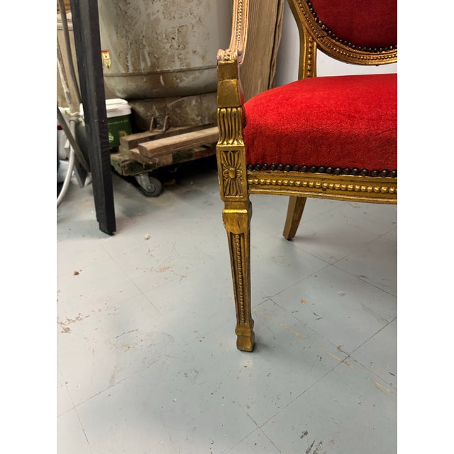 beautiful vintage arm chair with a antique gold finish upholster in red mohair fabric and decorative antique gold nail heads