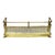 This antique brass fireplace fender, dating to approximately 1920, features a rectangular form with an intricately...
