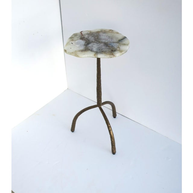 A contemporary drinks table featuring an organically shaped agate top with natural banding and translucent depth. The...