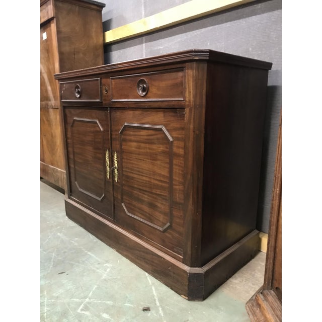 This sideboard has two drawers and a main niche with a shelf. Dimensions: 112x90x49 cm