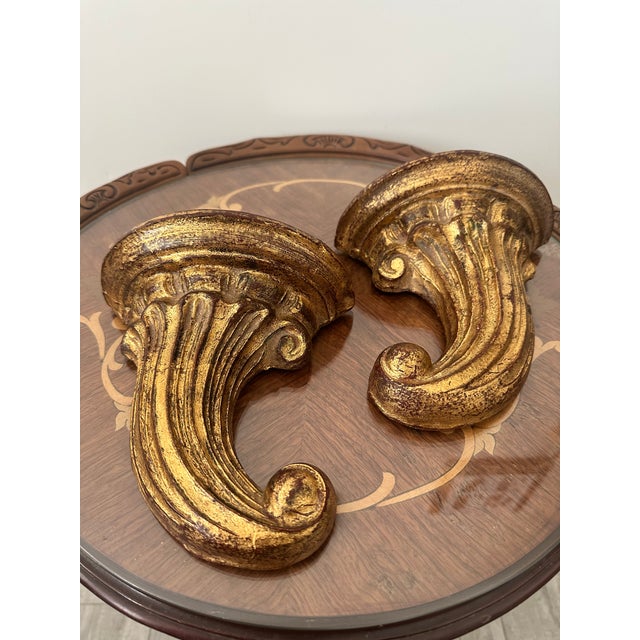 Mid 20th century Italian gilt wood shelf brackets with a lovely curled scroll. Made in Italy in the Florentia Style. These...