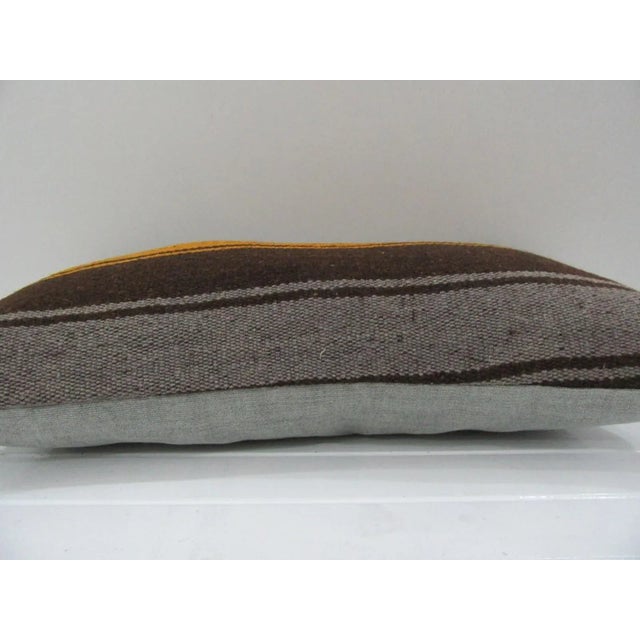 This is a pillow cover made from a vintage kilim rug. The piece was properly washed and ready to use. Pillow inserts not...