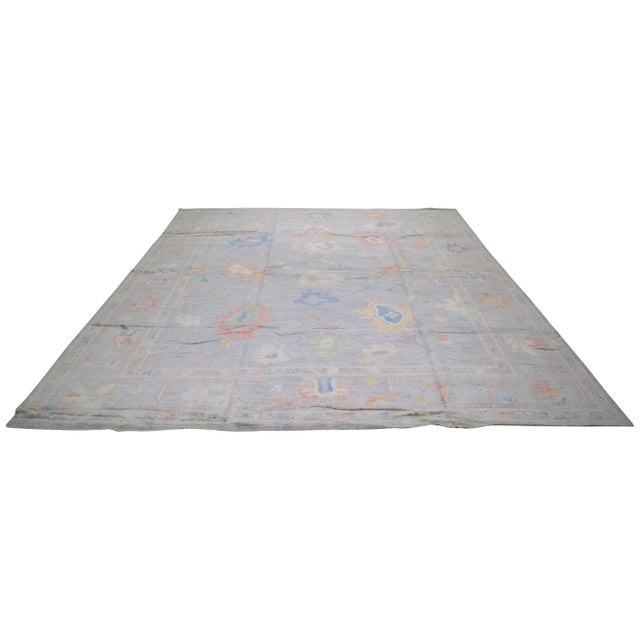 Oushak hand knotted wool rug with natural colors, floral style, and fine weave.