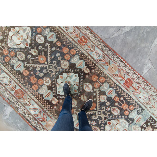 A delightful Oushak rug features a variety of intermingling designs such as florals, vase, and abstract medallions to...