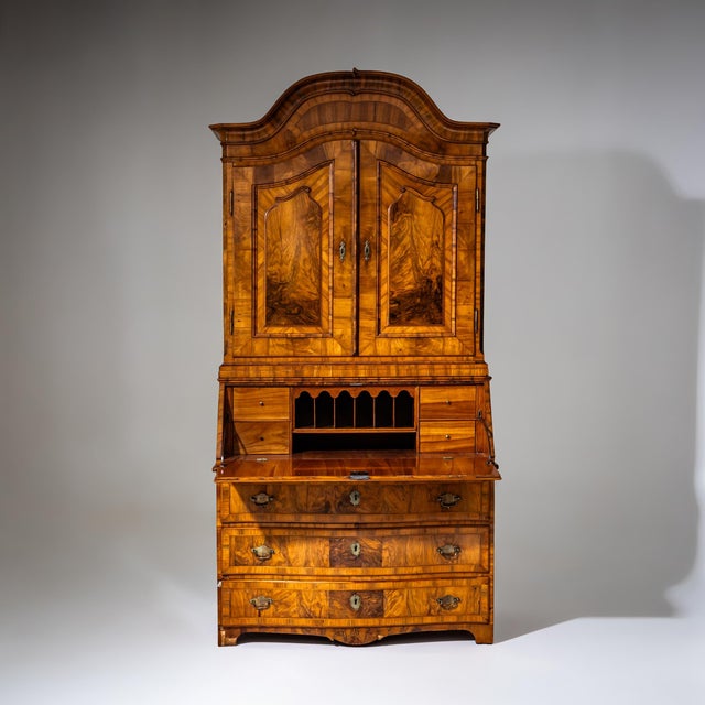 Baroque fall-front secretary veneered in walnut, featuring a commode base with three drawers and a slightly convex front....