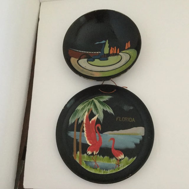 Black lacquerware plate and small dish from Japan are vintage souvenirs from Florida and the Great Smoky Mountains. The...