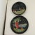 Black lacquerware plate and small dish from Japan are vintage souvenirs from Florida and the Great Smoky Mountains. The...