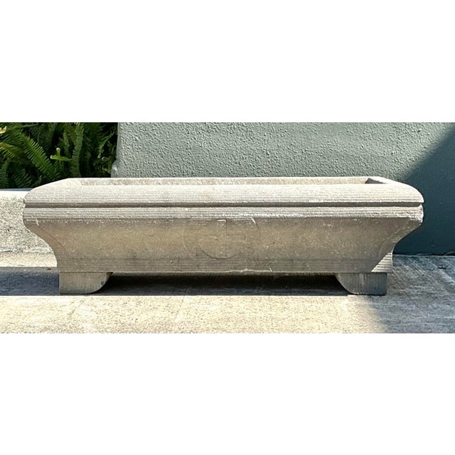 This magnificent architectural carved stone planter embodies the rugged elegance of traditional Mediterranean design....