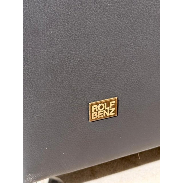 Elegant designer armchair by Rolf Benz, upholstered in high quality dark grey leather. This sophisticated lounge chair...