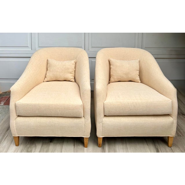 Here is a beautiful pair of vintage sculptural barrel chairs, newly professionally reupholstered in a soft pale apricot...