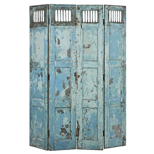 This weathered solid wood screen is a unique piece that combines functionality and aesthetics. Its aged blue patina...