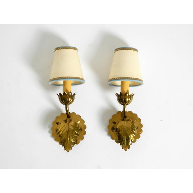 Two beautiful original 1950s brass wall lamps with a floral design. Elaborate, elegant design from the Mid-Century period....