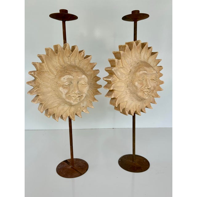 Pair of heavy, Hayes Parker sand cast or plaster sun face candelabras. Smiling suns mounted upon aged metal stands with...