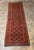 Dating to approximately 1900, this antique Baluch tribal runner is distinguished by its beautifully repetitive geometric...
