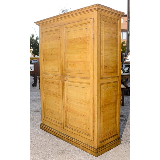 This majestic two-door wardrobe in solid fir wood, dating back to the 19th century in Italy, is a true antique that...