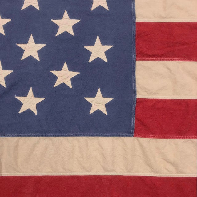 This oversize vintage American flag is made from a cotton cloth, with fully sewn stars and stripes. Flag has been...