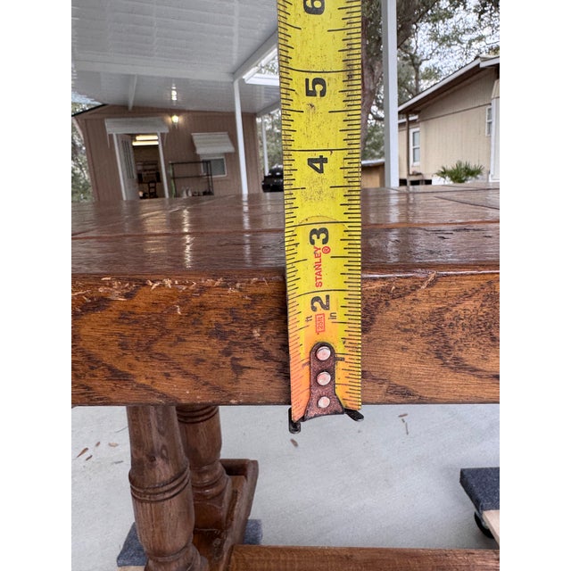 Superb oak refectory style dining table c.1930. Featuring a parkay style top made from solid oak, more than two inches...
