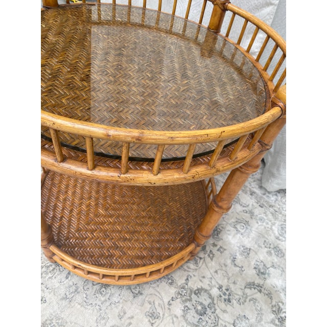 This vintage rattan and bamboo two tiered table has beautifully woven insets. I love the trim with the vertical bars of...