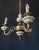 The chandelier is made of brass and bronze. It is adorned with beautiful ceramic elements featuring floral motifs. Decal...