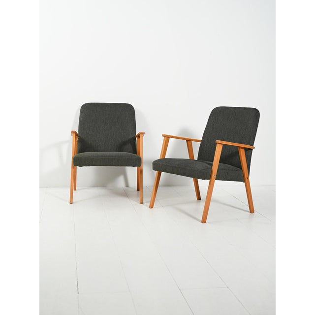 A pair of 1950s Scandinavian beech armchairs, with slanted lines and original dark gray upholstery, clean and bold. A pair...