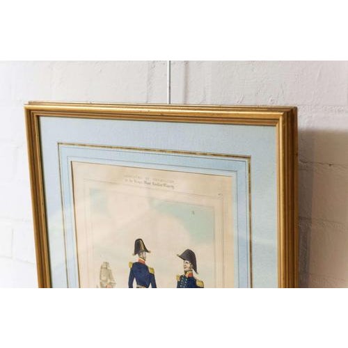 A framed and mounted c19th coloured print titled "captains, plate 5 from 'costume of the royal navy and marines'" engraved...