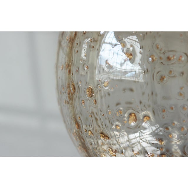 A unique, striking Italian pendant lamp that embodies the elegance and craftsmanship of Murano. Its spherical shade is...