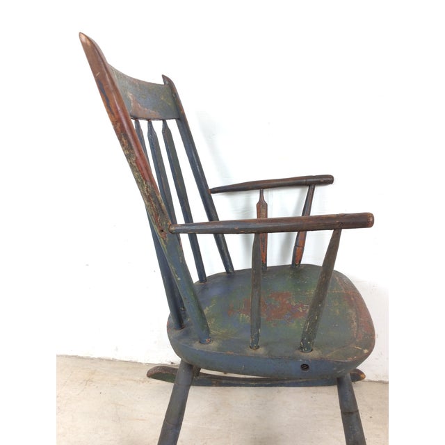 This antique children's rocker features. hardwood construction, spindle style arms and vintage black paint that has worn...