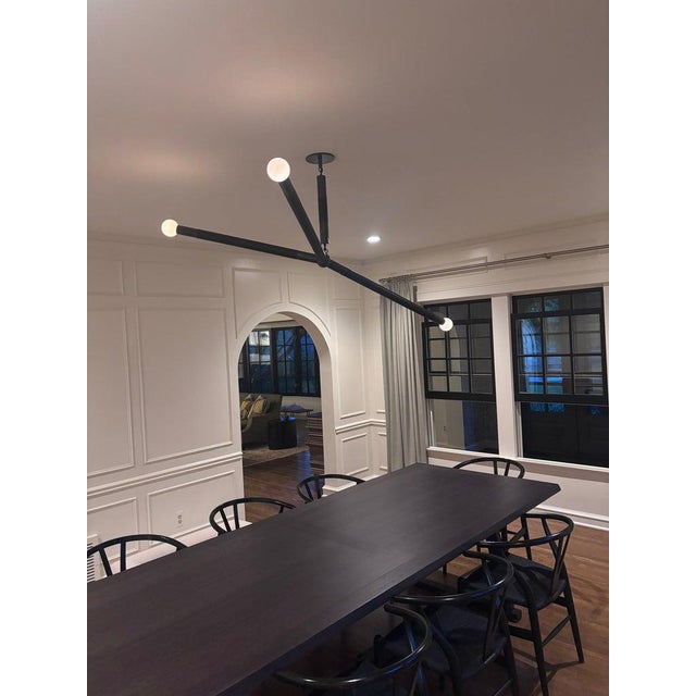 Large Arrow pendant by Apparatus Studio, finished in blackened brass and hand-wrapped in black leather. The Arrow is a...