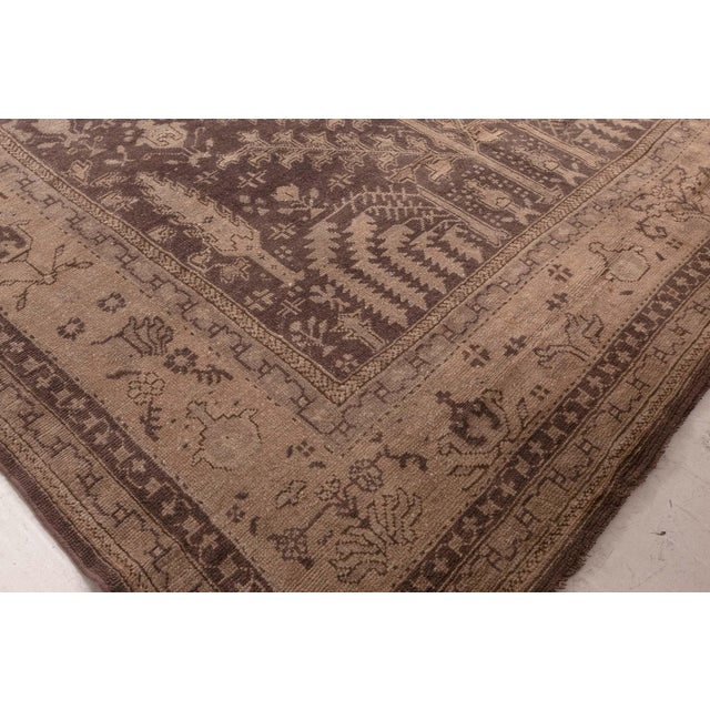 Subtly commanding and richly atmospheric, this antique Turkish Oushak rug from the 1920s captures the refined artistry of...