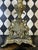 Pair of monumental brass candelabra in the Rococo Revival taste, featuring elaborate scrolling arms, pierced decoration,...