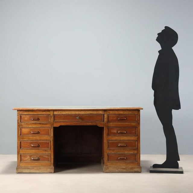 Walnut desk dating back to the early 20th century, featuring a functional and robust design. The top is enhanced by a...