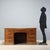 Walnut desk dating back to the early 20th century, featuring a functional and robust design. The top is enhanced by a...