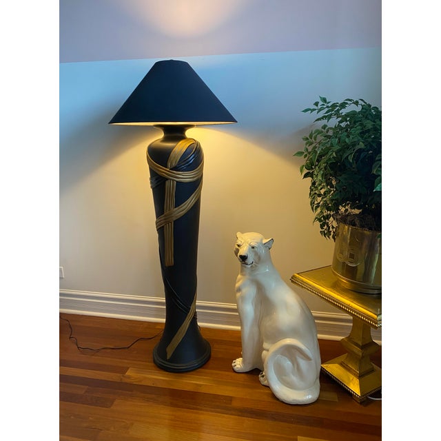 Beautiful dark and moody 1980s Art Deco black plaster floor lamp. Gorgeous gold and black ribbon wrapped design on black...