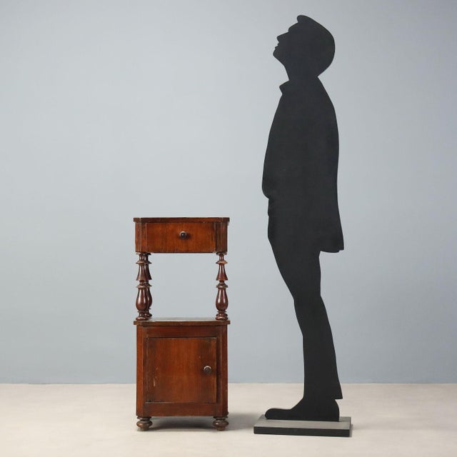 Louis Philippe nightstand made of walnut, dating back to the late 19th century. The elegant structure features a raised...