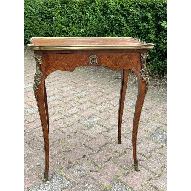 1860 Louis XV Fruitwood & Kingwood Marquetry Table – 1 Piece An authentic and finely crafted 19th-century French Louis XV...
