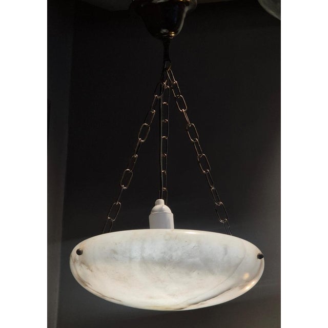 A beautiful pendant in alabaster with new wiring and black chains. Similar has been made by bröderna malmströms...