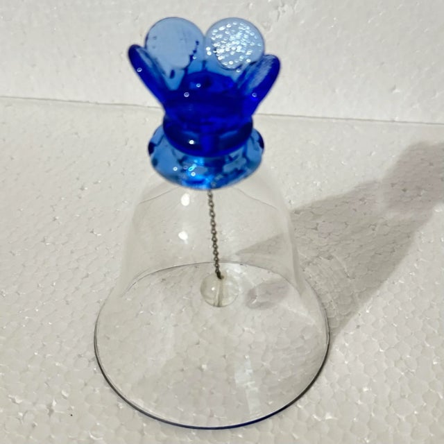 Beautiful glass bell with a blue flower shaped handle.