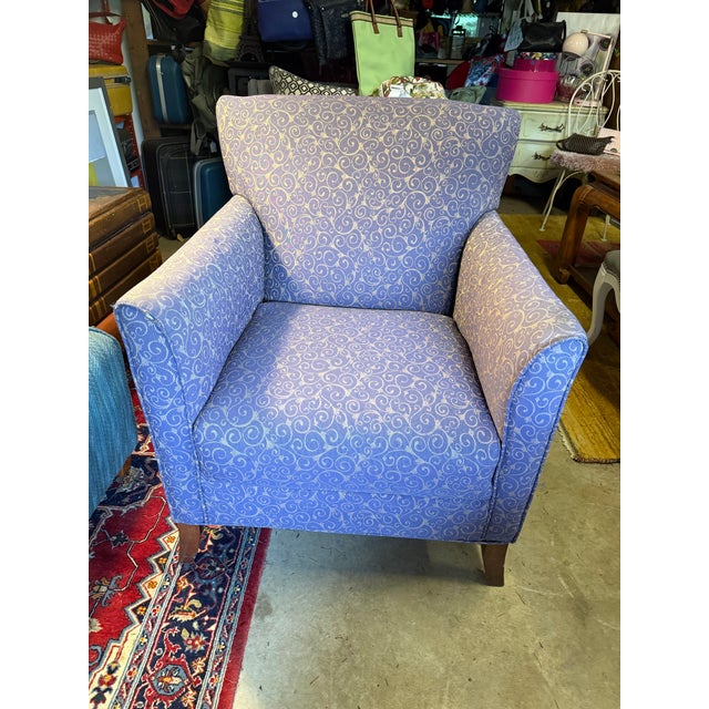 This purple club chair is ready to sink into with its beautifully upholstery and comfy padded armrests!