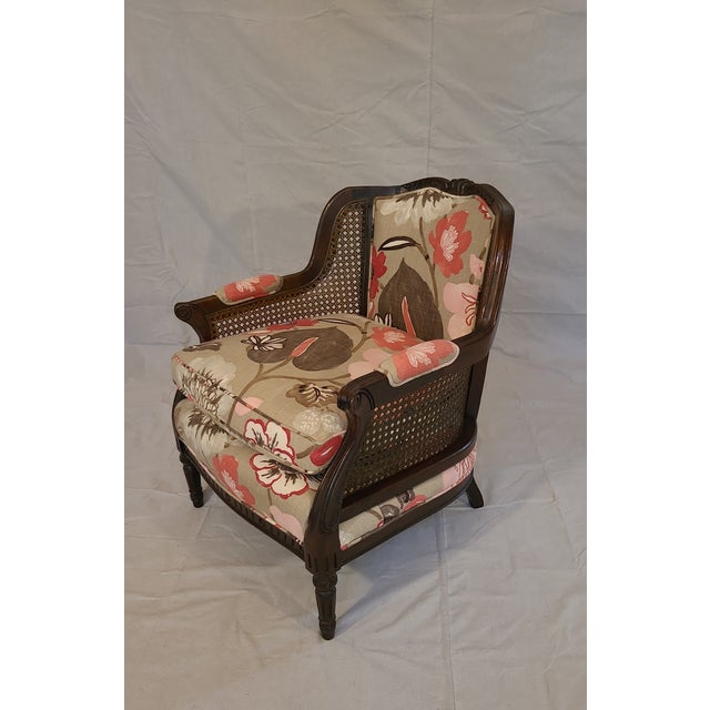 This is a wonderfully re-upholstered cane lounge chair. The arms and back are in near perfect condition and with the new...