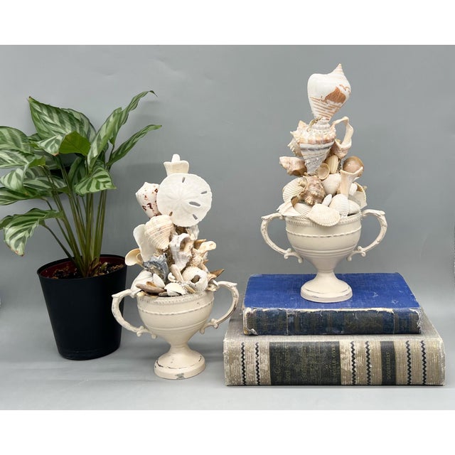 Striking pair of modern artist-made shell topiary sculptures, each composed from an assortment of natural seashells, sand...