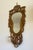 A carved and painted mirror with candle bracket. In the Florentine style. Italian circa 1930.