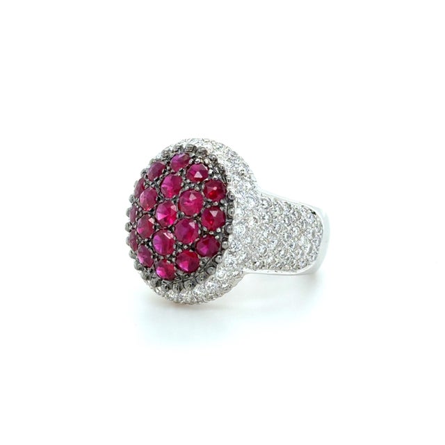 This stunning ring designed by famous Persian design house Mouawad, boasts a cluster of bright rose cut treated rubies...
