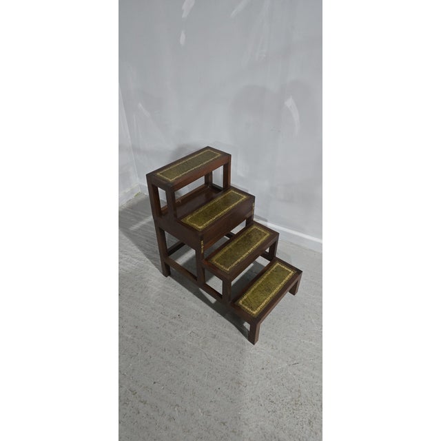 A very nice pair of mahogany library steps with leather treads, folds over to make a single step or small table, very good...