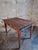 This antique French table dates from circa 1920 and features a solid pine top combined with an oak base and legs. The...