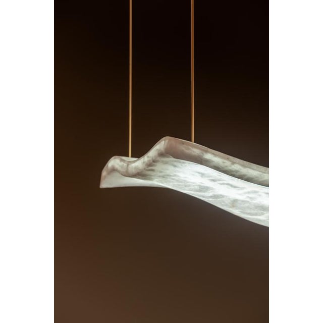 Aire medium pendant lamp by united alabaster dimensions: d 65 x w 65 x h 18 (customizable height) materials: alabaster,...