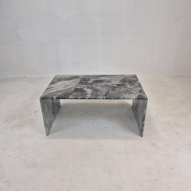 Very nice Italian coffee or side table handcrafted out of marble, 1970s. The rectangle top and the two feet are made of...