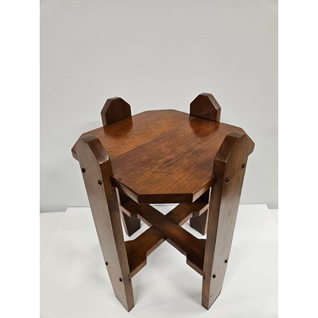 A classic Arts and Crafts or Mission style plant stand. This mahogany plant stand features a carved stretcher at the base....