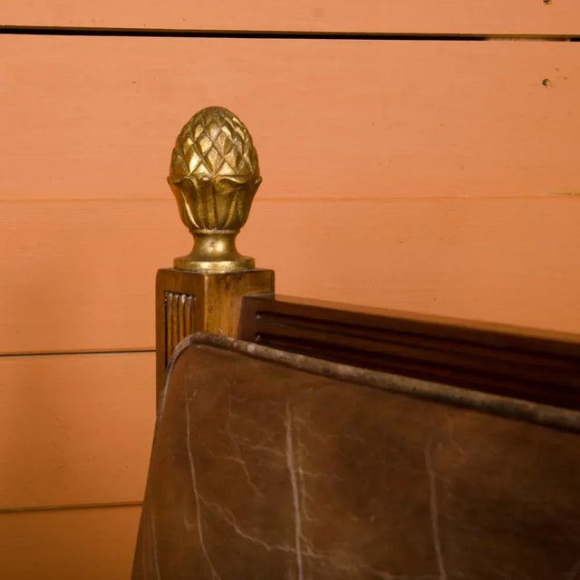 A Ornamental 1920 leather and wood armchair. having well-shaped and generous proportions with bronze gilt mounts.In style...